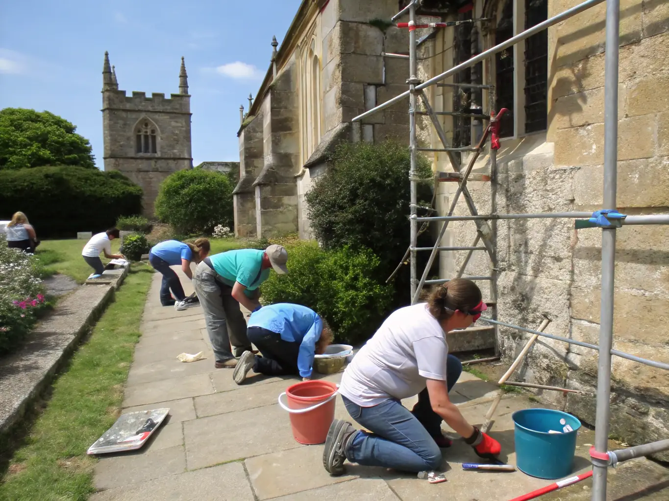 A group of volunteers working together to maintain and preserve the artworks on display.